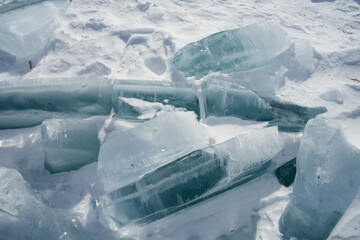 transparent ice floes lie on the surface of a frozen lake