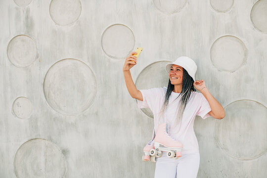 Female roller skater taking selfies
