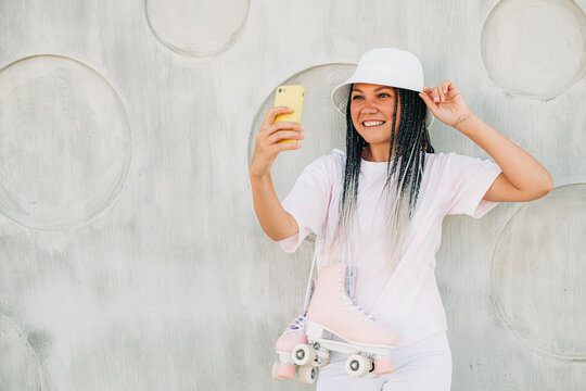 Woman roller skater taking selfies