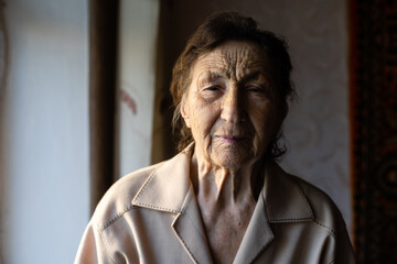 beautiful over very old woman at home near the window