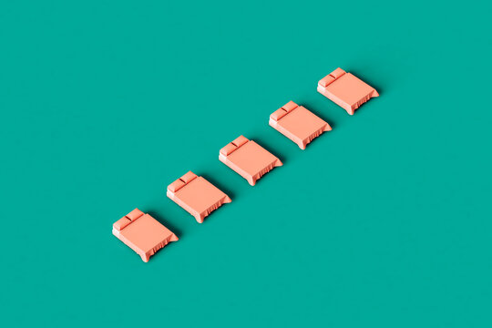 row of tiny Pink beds on a green background
