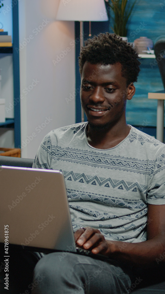Poster business man using laptop for remote work while sitting on couch. entrepreneur working from home wit