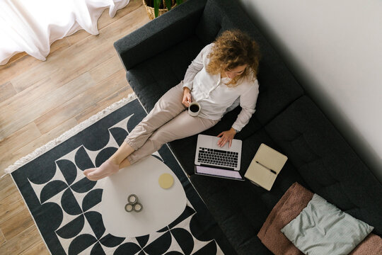 Overhead image of woman working from home using laptop