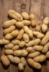peanuts in shells on wooden background