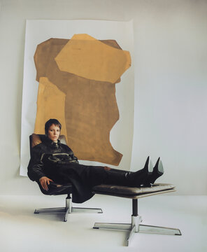 Fashion Top Model In Front Of Abstract Paintings.