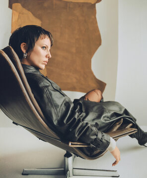 Fashion Top Model In Front Of Abstract Paintings.