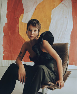 Fashion Top Model In Front Of Abstract Paintings.