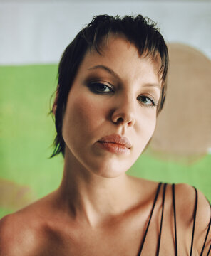 Fashion Top Model In Front Of Abstract Paintings.