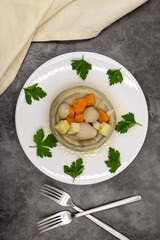 Artichokes with olive oil on a dark background. Traditional delicious Turkish food; (zeytinyagli enginar). Top view. Close up