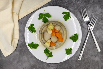 Artichokes with olive oil on a dark background. Traditional delicious Turkish food; (zeytinyagli enginar). Top view. Close up