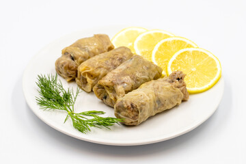 Stuffed cabbage leaves, in a ceramic plate. Vegan cabbage rolls, cooked cabbage leaves, wrapped around a filling of rice, onions and spices. (Lahana sarması) Horizontal view. Close up