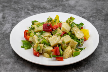 Artichoke salad with olive oil on dark background. Traditional delicious Turkish food; (zeytinyagli enginar). Horizontal view. Close up