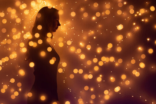 Silhouette of  woman surrounded by lights