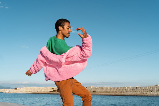 Portrait of fashion  young man dancing outdoors - Powered by Adobe