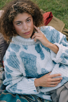 Portrait Of Young Curly Haired Woman Outdoors.