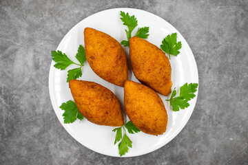 Kibbeh on a dark background. Kibbeh is a popular dish in Middle Eastern cuisine. Stuffed Meatballs...
