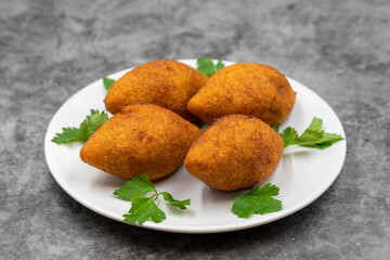 Kibbeh on a dark background. Kibbeh is a popular dish in Middle Eastern cuisine. Stuffed Meatballs Food, Falafel, icli Kofta, Quibe. Horizontal view. Close up