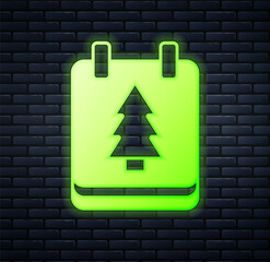 Glowing neon Christmas day calendar icon isolated on brick wall background. Event reminder symbol. Merry Christmas and Happy New Year. Vector