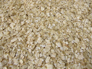 Fine rolled oats flakes on a wooden board