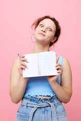 Young woman learning with notebook and pen close-up unaltered