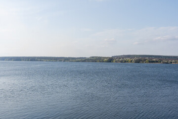 Water surface with ripples and sunrays reflections