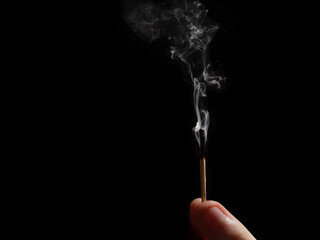 Wooden matches with fire on a black background