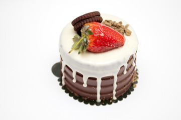 A chocolate cake with strawberries and cream.