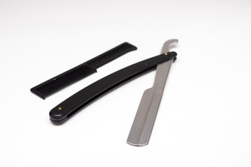 Black straight razor on a white background