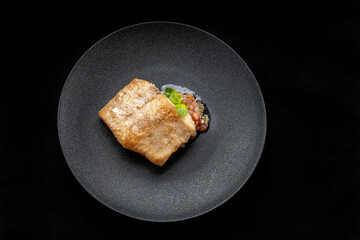 Delicious fish fry served on a beautiful plate, laid out on tartare.