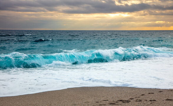 turquoise sea and wave at sunset