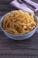 Italian pasta raw and uncooked isolated on wooden table