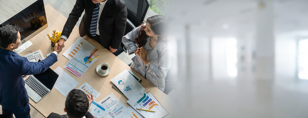 Group business people handshake at meeting table in widen view in office together with confident...