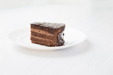 Chocolate cakeclose-up is on a white plate. - 478971874