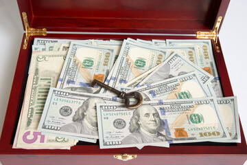 Case box full of dollars. There is a metal key on the paper money - 478971883