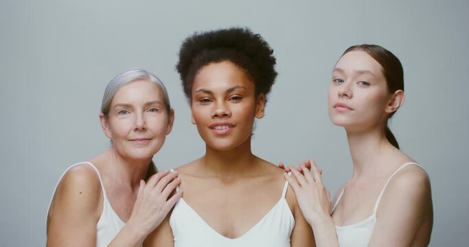 Caucasian models with large age differences stand beside African-American woman