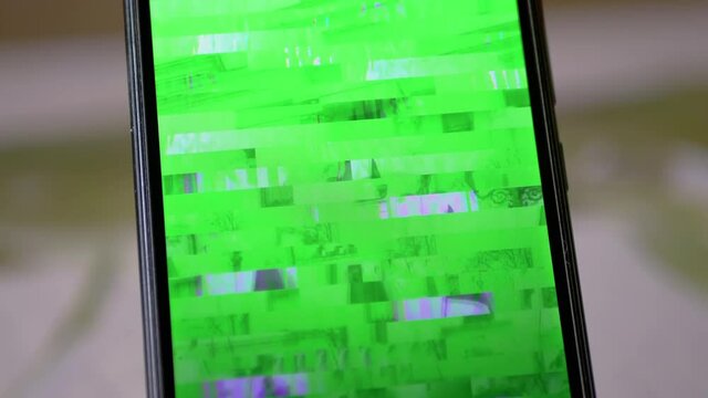 Signal Distortion, Interference, Glitches on the Screen of a Smartphone, Mobile Phone. Digital video transmission error, purple, green stripes, pixel noise. Technical problem, lack of internet, web.