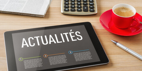 A tablet with the headline News in french - Actualités