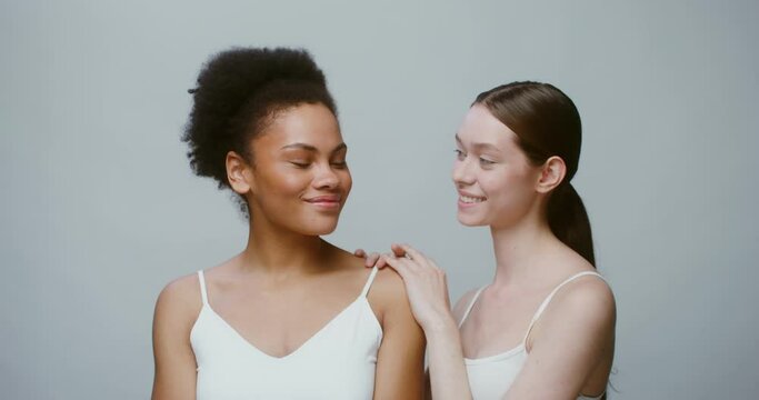 An African-American woman and a woman of European appearance without makeup