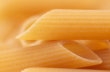 Close-up dry pasta as background.