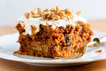 slice of Carrot cake with cream cheese frosting close up