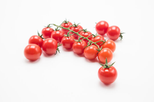 Small tomatoes on a white background.tomato cherry on branch isolated on white background