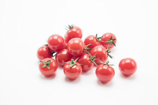 Small tomatoes on a white background.tomato cherry on branch isolated on white background