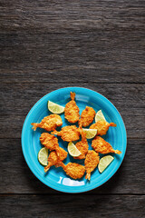 Crispy Fried Butterfly Shrimp on a blue plate