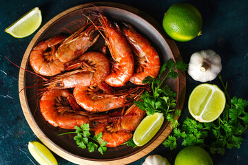 Close up Fried langoustines and shrimps on a plate with parsley. Pickled in garlic and lime. Top view