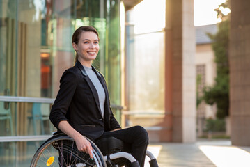 Disabled businesswoman in a wheelchair - obrazy, fototapety, plakaty