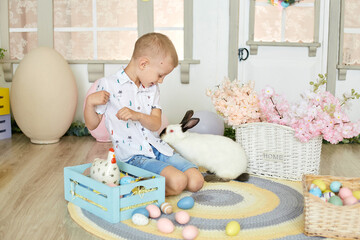 Fototapeta na wymiar happy easter. happy funny boy playing with Easter bunny.