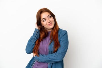 Young redhead woman isolated on white background thinking an idea