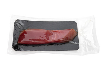 Vacuum packed tuna on a white background. A piece of fresh tuna in the package close-up on a white background.