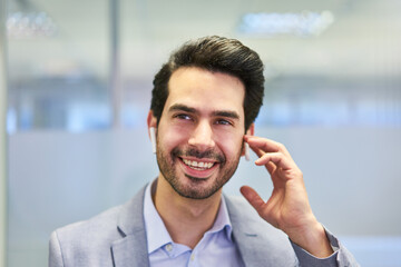 Smiling young businessman with bluetooth headset