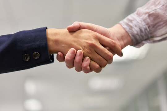 Business people at shakehands as a symbol of greeting
